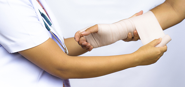 Doctor putting wraps around patients arm